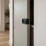 Pocket door lock installed on a door sliding into the wall